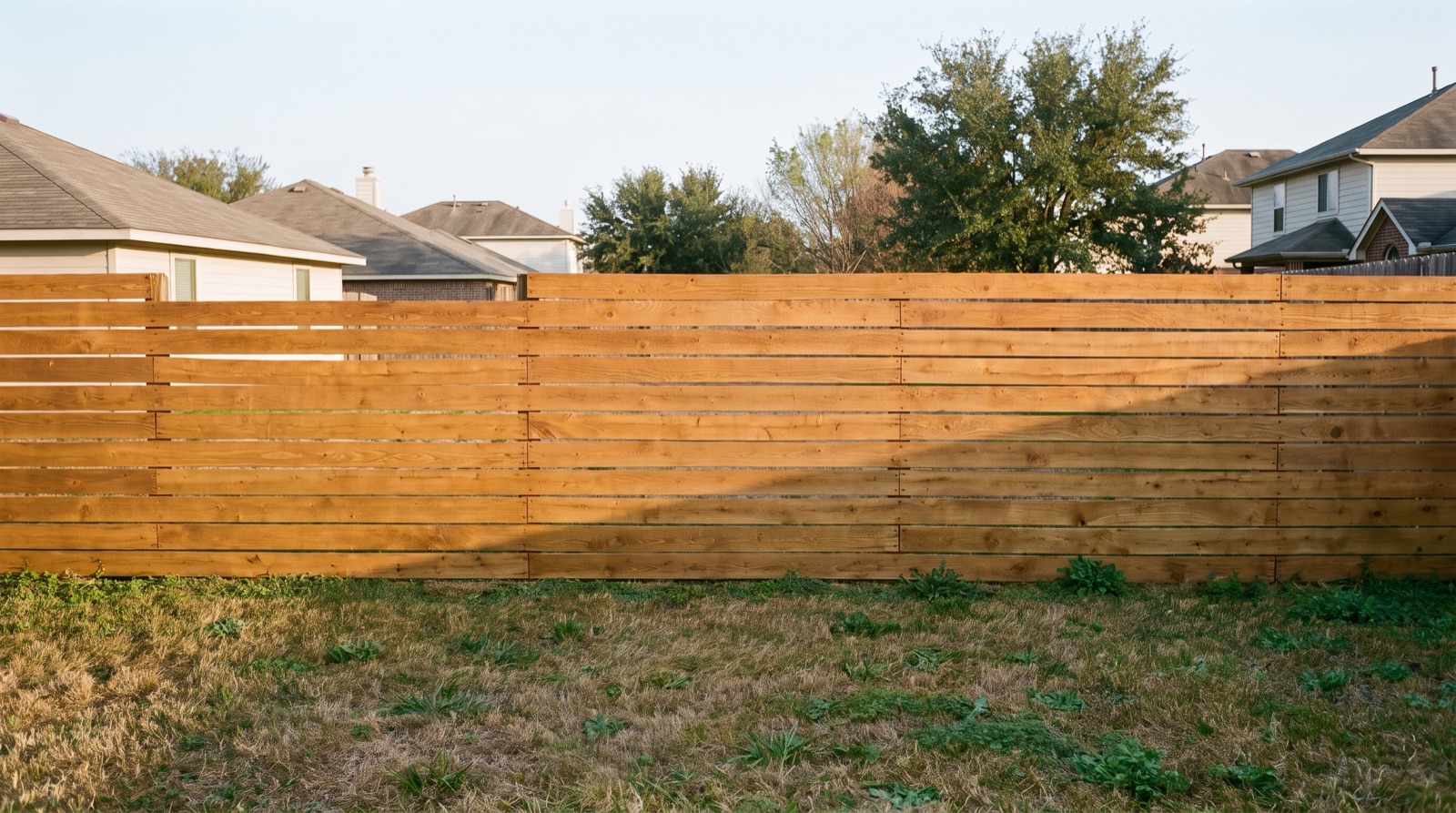 The same horizontal fence restored to a honey-cedar tone